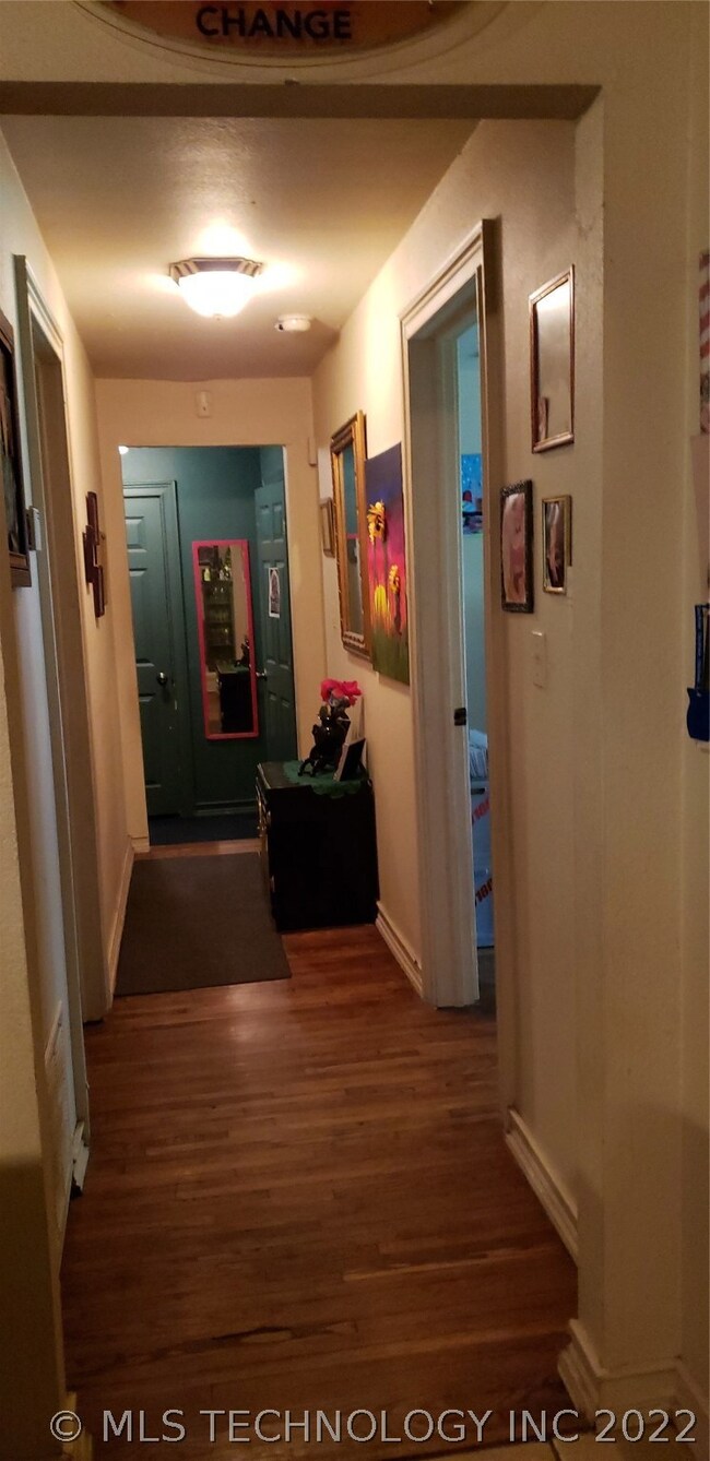 Hall from kitchen. Green door at end of entry is u