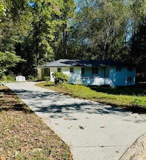 Ranch-style home featuring concrete driveway