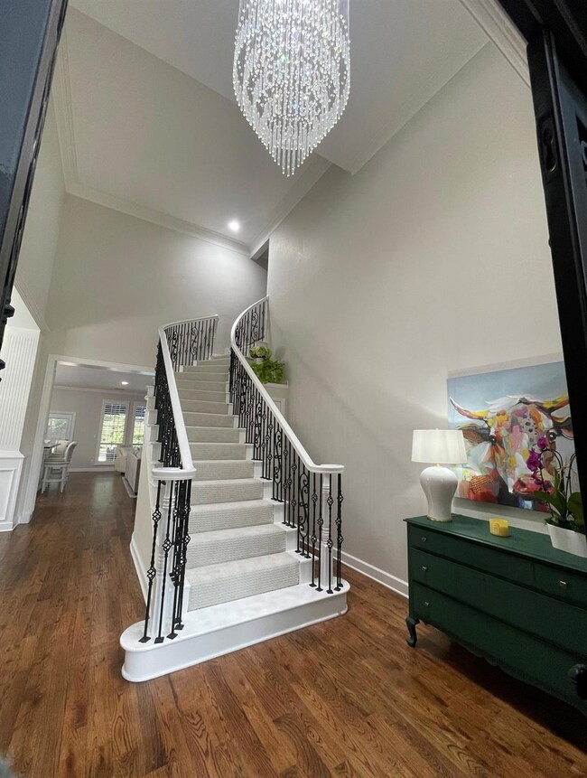 Stairway featuring high vaulted ceiling, new carpe