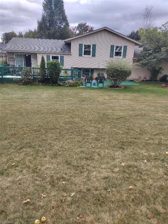View of front of home with a wooden deck and a fro
