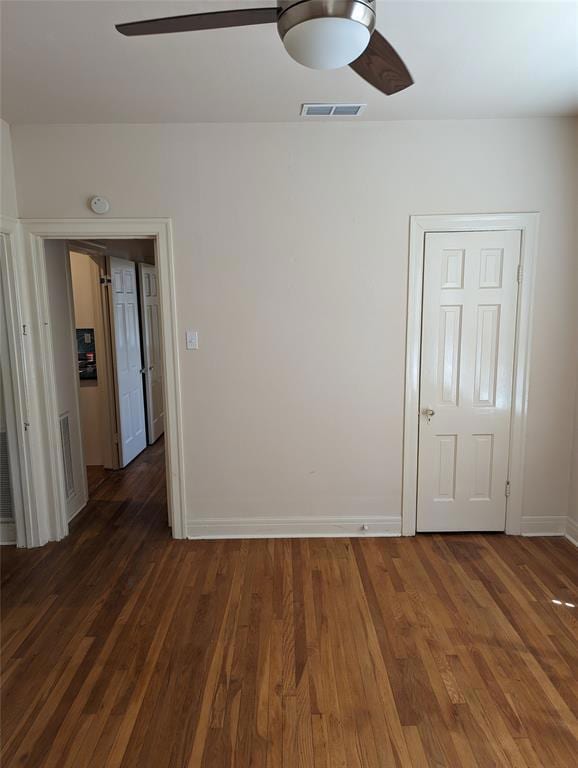 Spare room with ceiling fan, wood finished floors