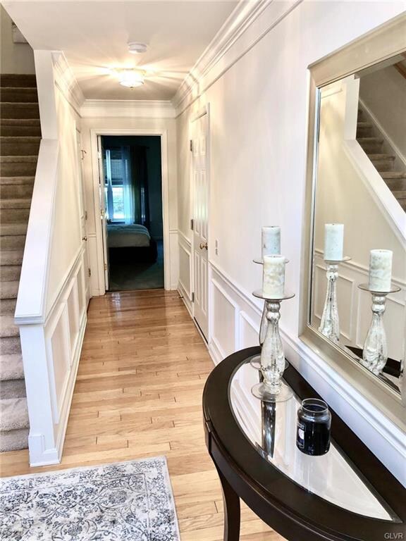 Entry foyer is highlighted by gleaming hardwood fl