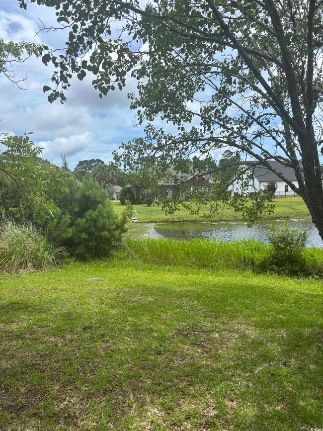 View of green lawn with a water view