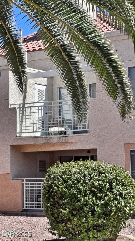 View of side of property featuring a balcony and s