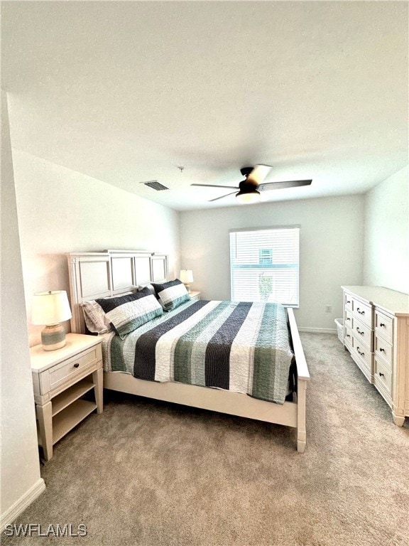 Bedroom with a textured ceiling, carpet, and ceili