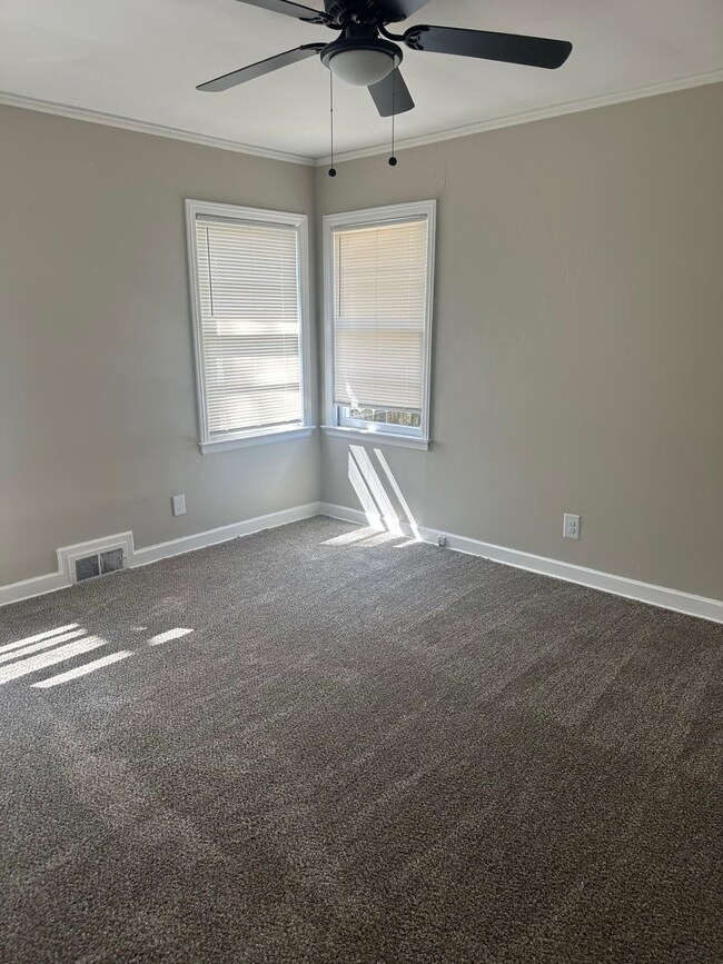 Spare room featuring carpet flooring, baseboards, 