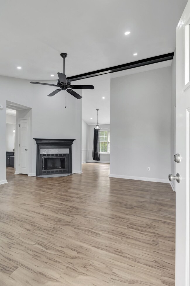 Spacious living room with soaring ceilings. A wood burning fireplace is there for chili evenings.