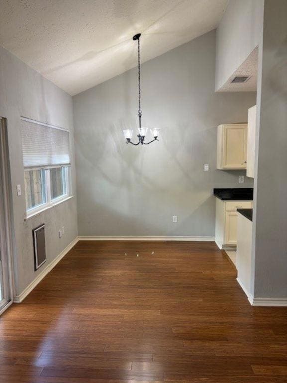 Unfurnished dining area featuring lofted ceiling,