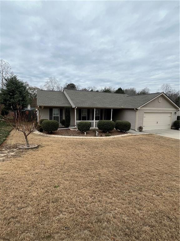 Single story home with a porch, driveway, roof wit