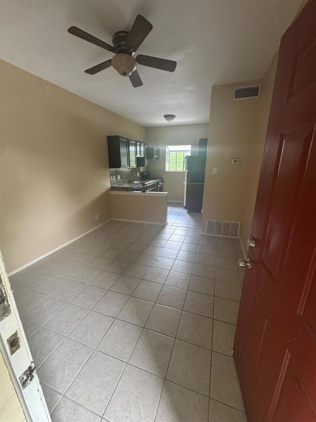 Unfurnished living room featuring light tile patt