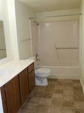 Bathroom featuring vanity, shower / bathtub combination, and toilet