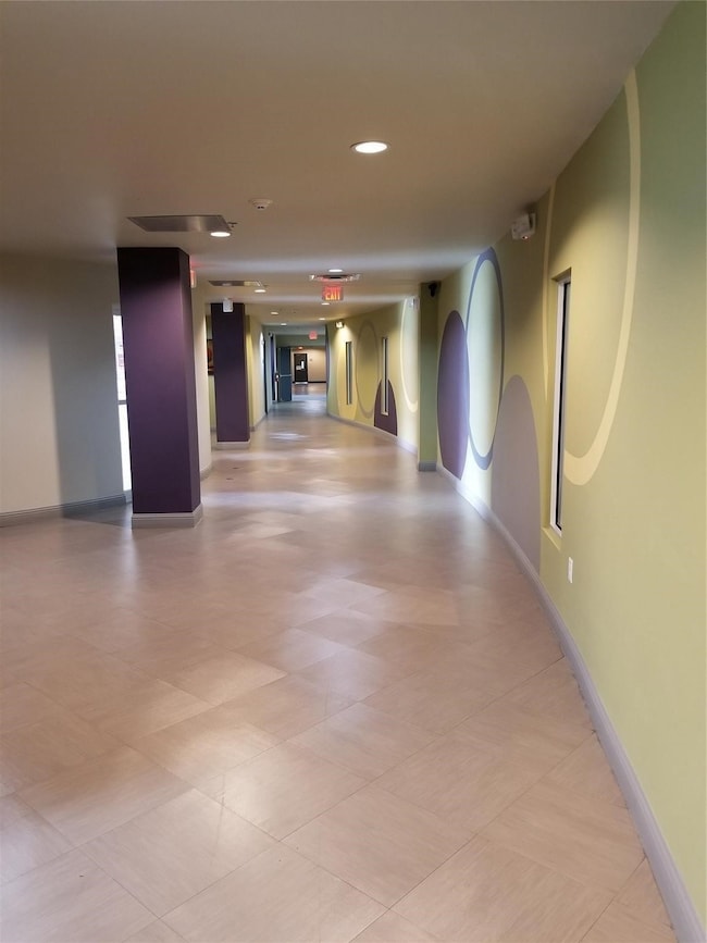 Hallway featuring baseboards and recessed lighting