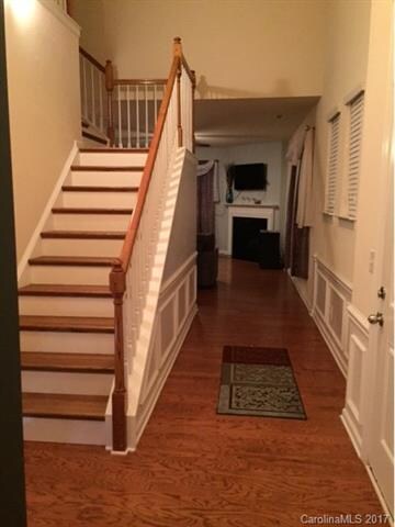 Hallway looking to family room with gleaming hardwood floors