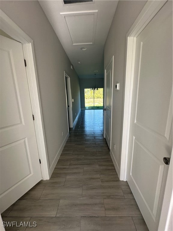 Hallway featuring dark wood-type flooring and an i