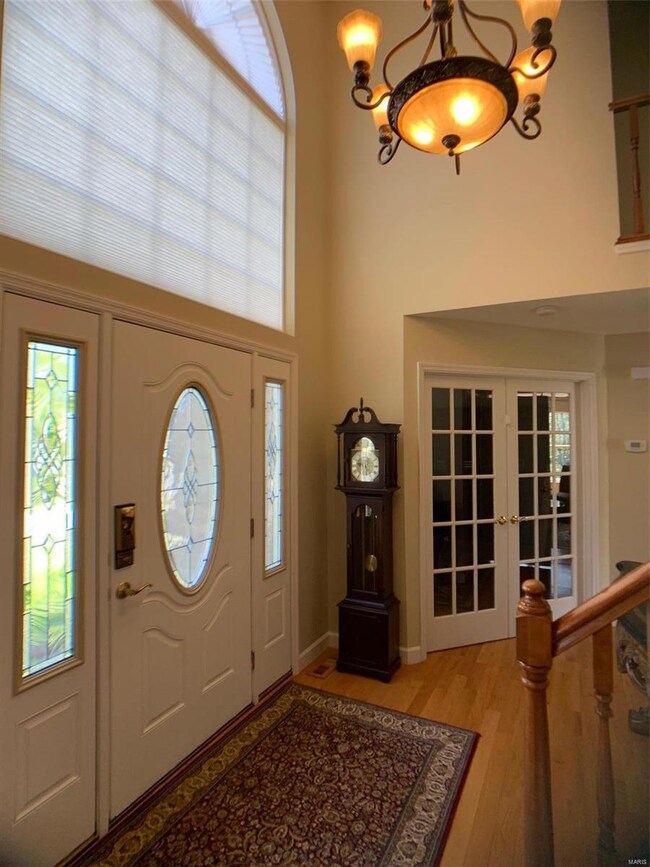 Formal foyer, front door and french door to the de