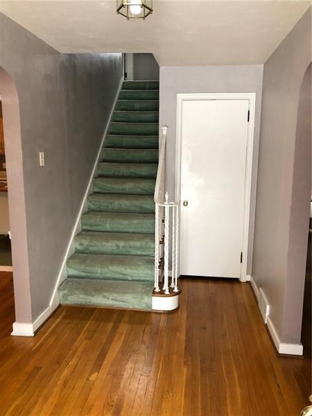 Large foyer with a guest closet and staircase lead