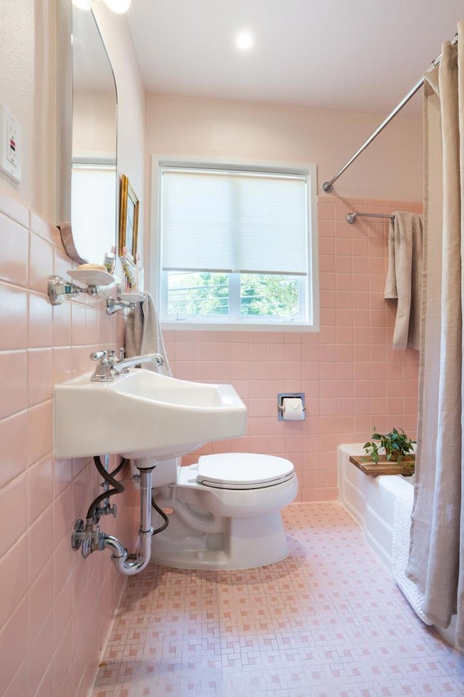 Bathroom with tile walls and shower / bath combo 