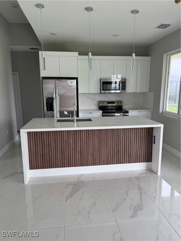 Kitchen with fridge, range, modern cabinets, a sin