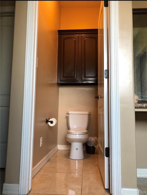 Bathroom featuring tile flooring and toilet