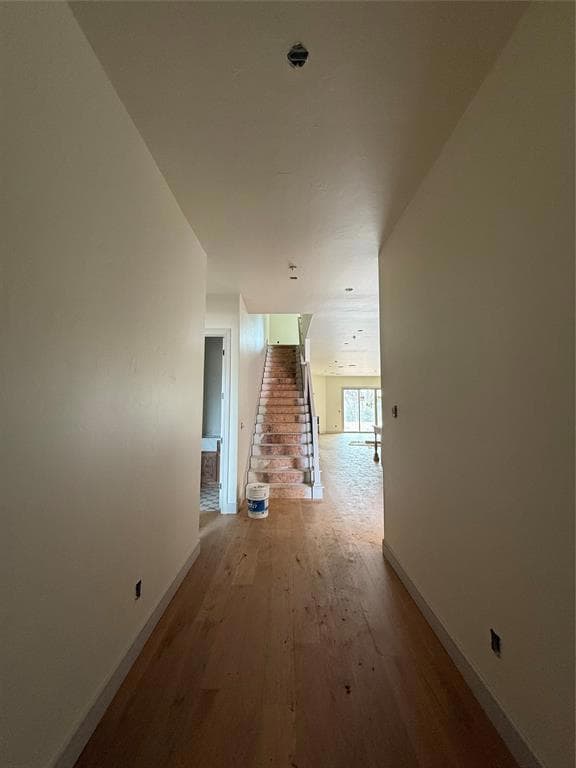 Hall featuring stairs, light wood-style flooring, 