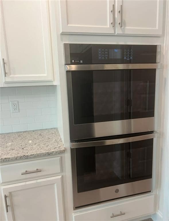 Room details with tasteful backsplash, white cabin