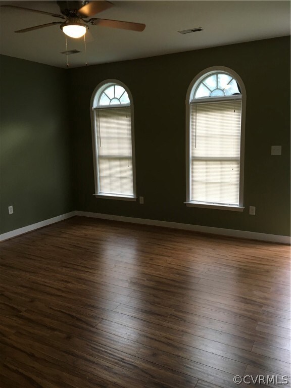 Living room with palidium windows and new ceiling fan.