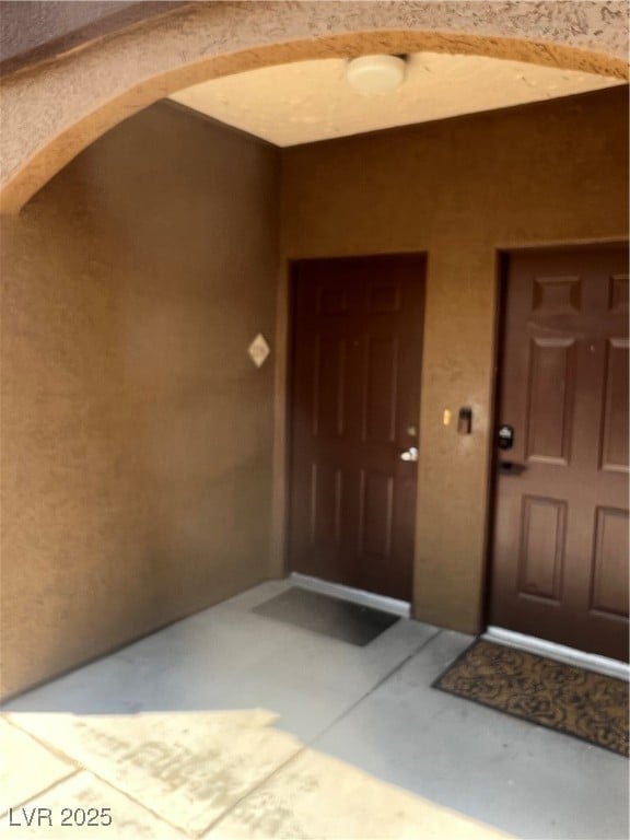 Entrance to property featuring stucco siding