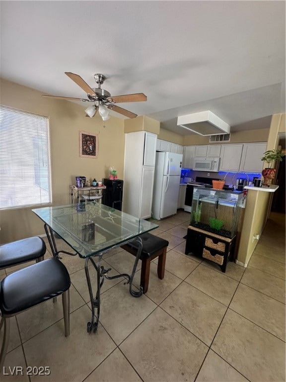 Dining space featuring light tile patterned floors