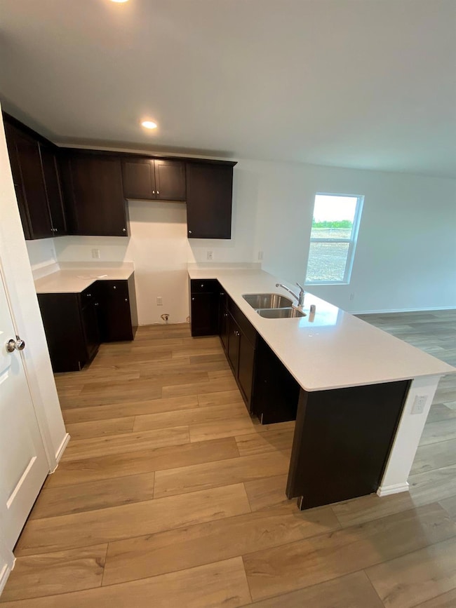 Kitchen with recessed lighting, light countertops,