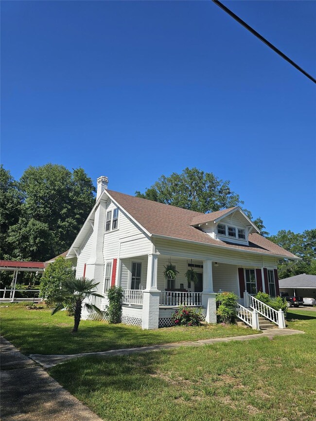 View of home's exterior with covered porch and a l