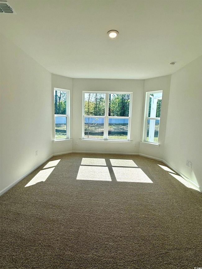 Carpeted spare room with recessed lighting, visibl