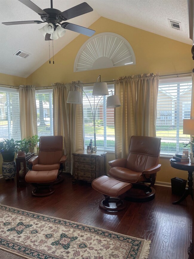 Living room with high vaulted ceiling, ceiling fan