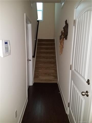 Hallway with laundry, garage entrance, and access 