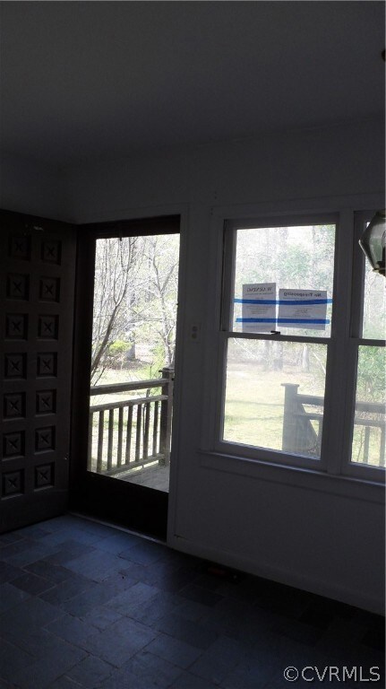 Front Door opens to Bright Foyer with Slate Floor
