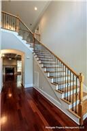 An impressive two story foyer greets guests and shows off the home's handsome cherry wood floors and one of its two firelplaces.