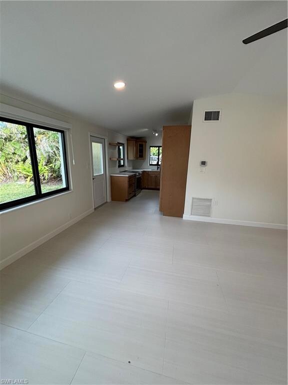 Unfurnished living room featuring ceiling fan