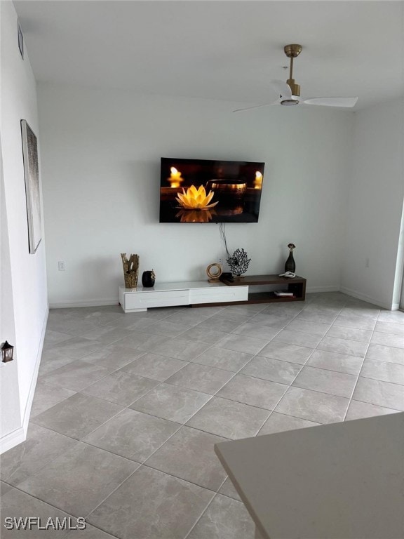 Unfurnished living room with light tile patterned floors and ceiling fan