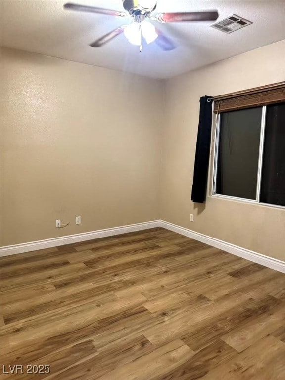 Unfurnished room featuring light wood-type flooring, a ceiling fan, and a textured ceiling