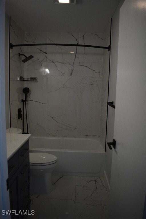 Full bathroom featuring marble finish floor, toile