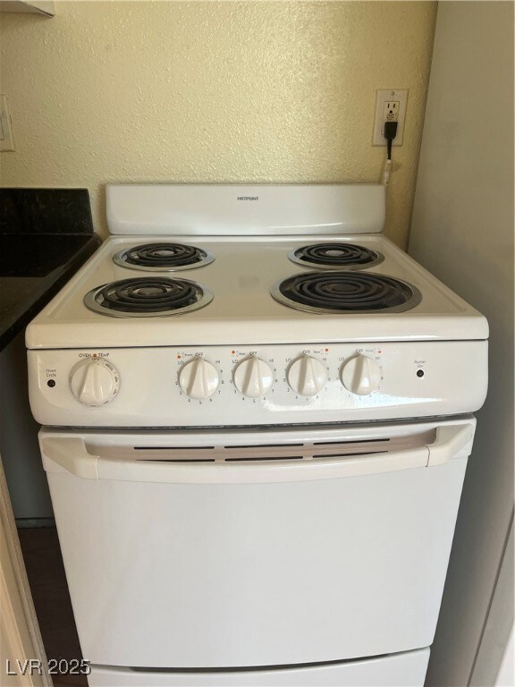 Room details featuring white electric stove