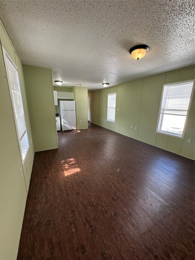 Bright and inviting living area seamlessly connecting to the kitchen for an open and airy feel.