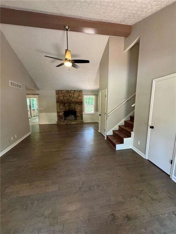 Unfurnished living room featuring a ceiling fan, beamed ceiling, stairs, dark wood-style floors, and high vaulted ceiling