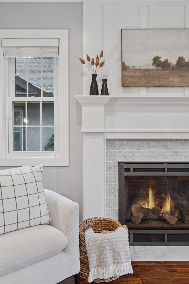 Crafted details stand out here: custom mantle and trim, a clean tile surround, and a high-quality gas insert. A polished, stone-look hearth completes this timeless focal point.