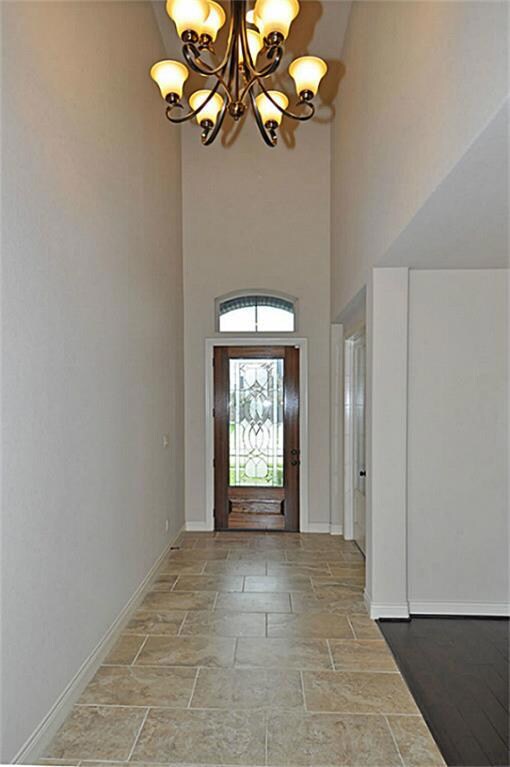 Adjacent to the entry is a study and private hall leading to the downstairs fifth bedroom with full bath.