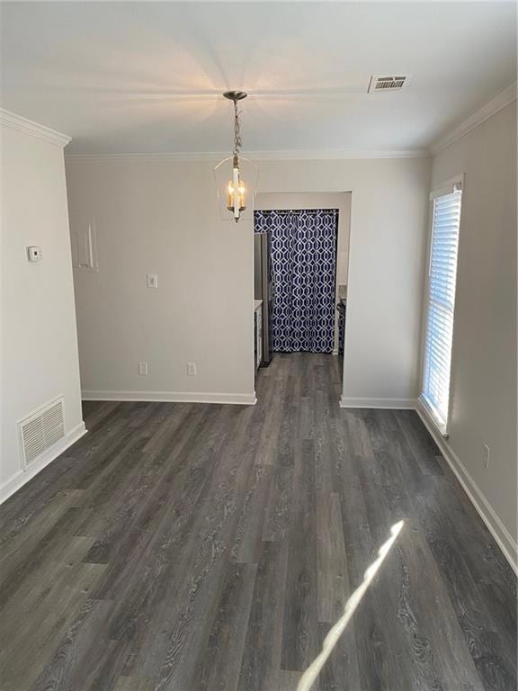Unfurnished dining area featuring a chandelier, crown molding, and dark wood-type flooring