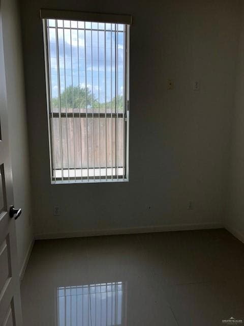 Empty room featuring baseboards