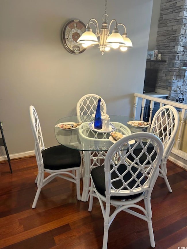 Dining space with a notable chandelier, baseboards
