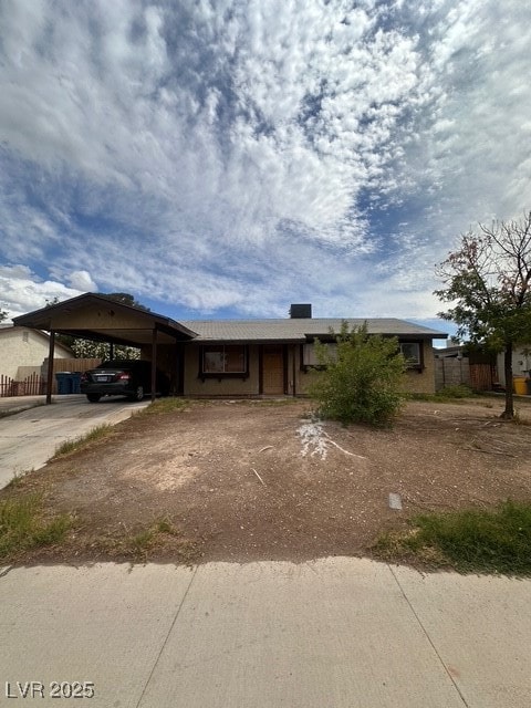 Ranch-style home with concrete driveway, an attach
