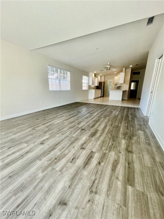 Unfurnished living room featuring light wood-type