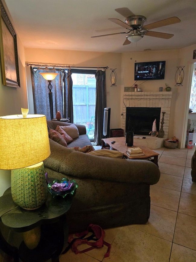 Living room featuring ceiling fan, tile & patterne